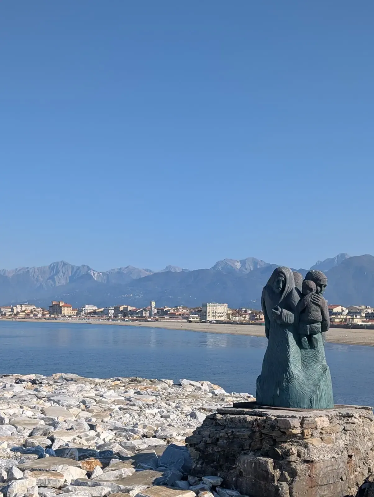 A monument on the breakwater; the Alps stand behind my home town.